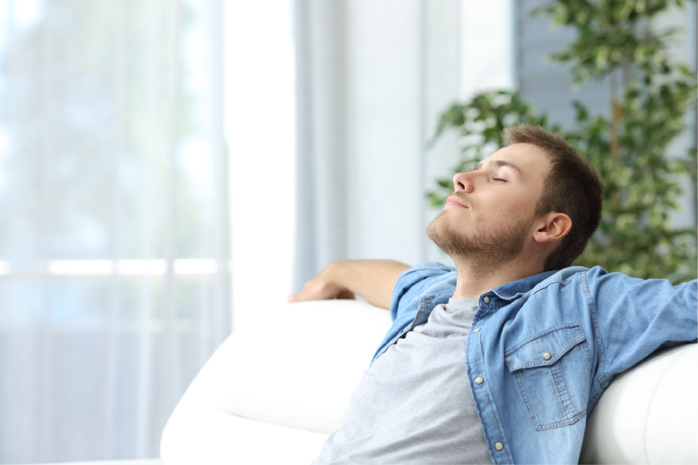 man resting sitting on a couch at home | Advanced Heating and Air Conditioning
