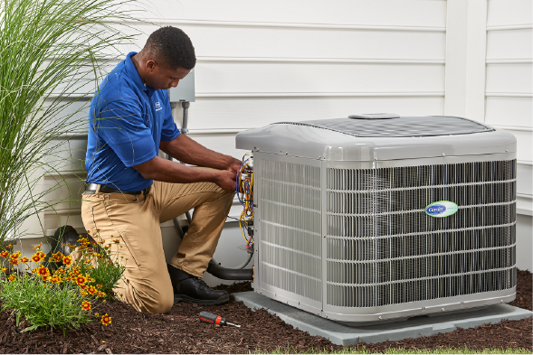 man working on carrier unit | Advanced Heating and Air Conditioning