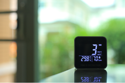 air quality sensor placing on a table indoor. | Advanced Heating and Air Conditioning