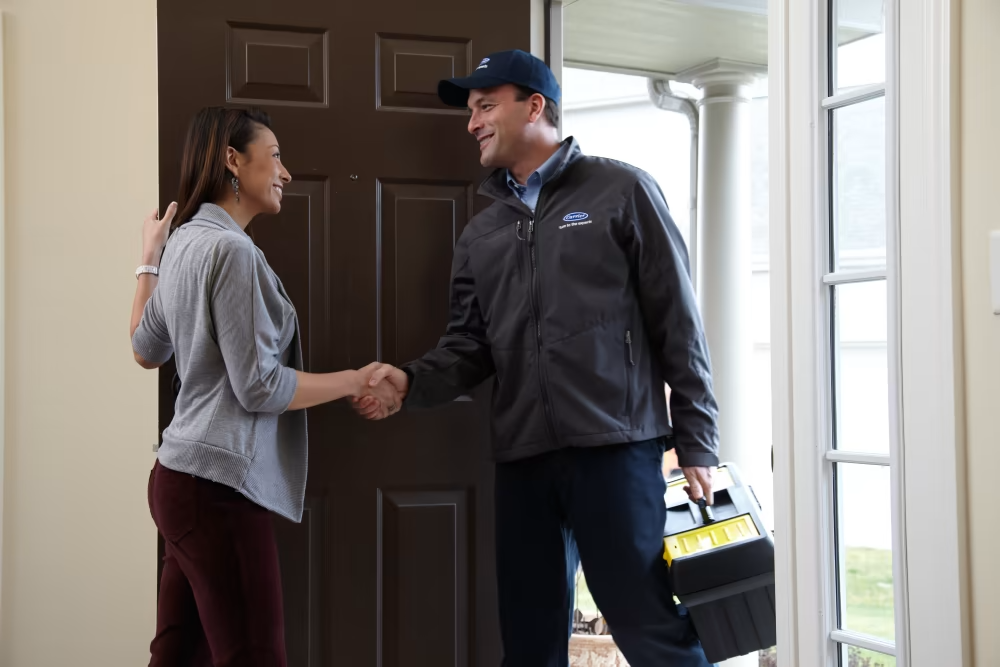 carrier technician shaking female hands | Advanced Heating and Air Conditioning